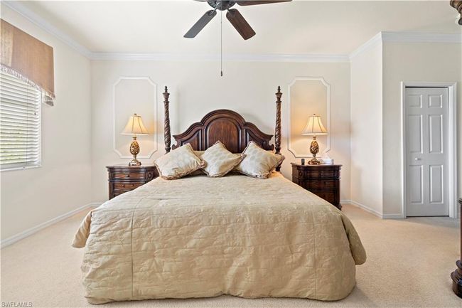 Carpeted bedroom featuring baseboards, ornamental molding, and a ceiling fan | Image 18