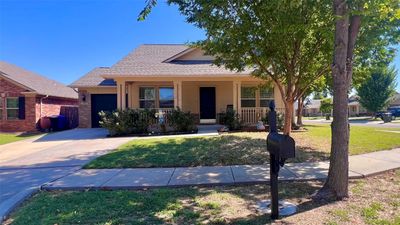 View of front facade with a front yard and a porch | Image 1