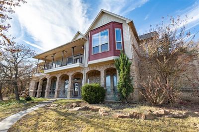 View of front facade with covered porch and a balcony | Image 1