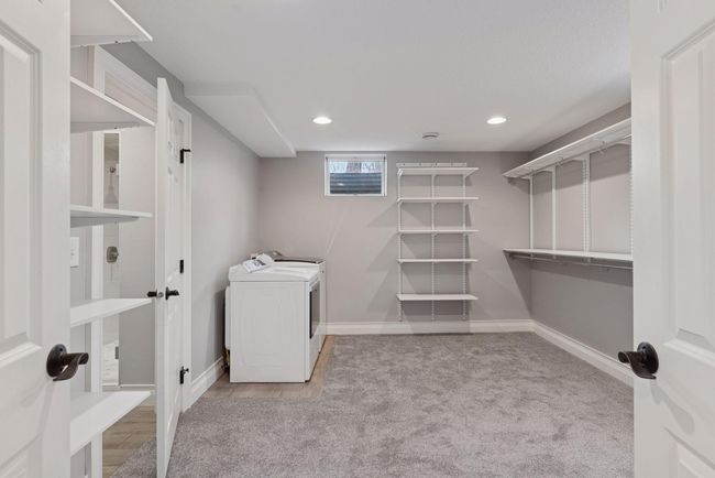 Lower level bedroom has an adjoining walk in closet and 2nd set of washer and dryers. | Image 32