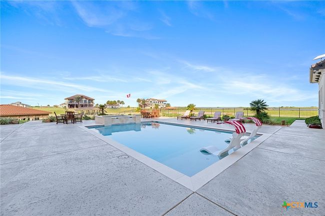 Pool with Tanning Ledge and Hot Tub with Poolside Seating Area | Image 33