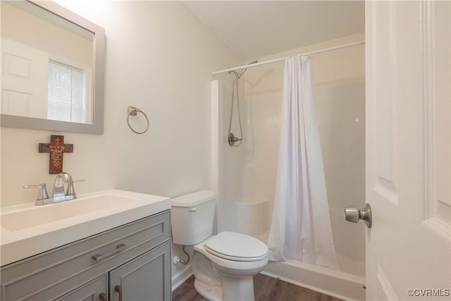 Full bath with toilet, vanity, a stall shower, and wood finished floors | Image 27