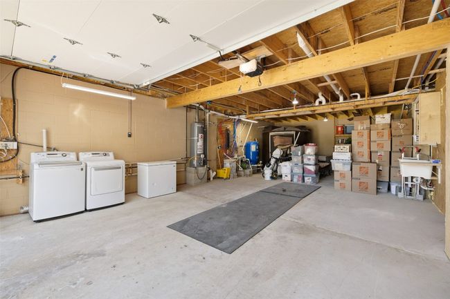 Garage with washer and dryer plus more storage area. | Image 18