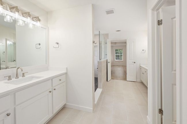 Full bath featuring walk-in shower with rainfall feature and shower wand. Double vanity quartz countertops | Image 22