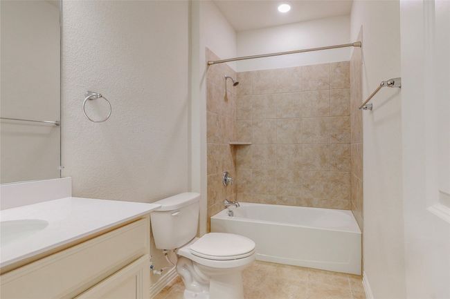 Full bath with tile patterned floors, vanity, toilet, shower / bath combination, and baseboards | Image 14