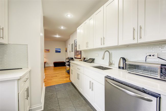 Kitchen with a sink, white cabinetry, dishwasher, decorative backsplash, and recessed lighting | Image 4