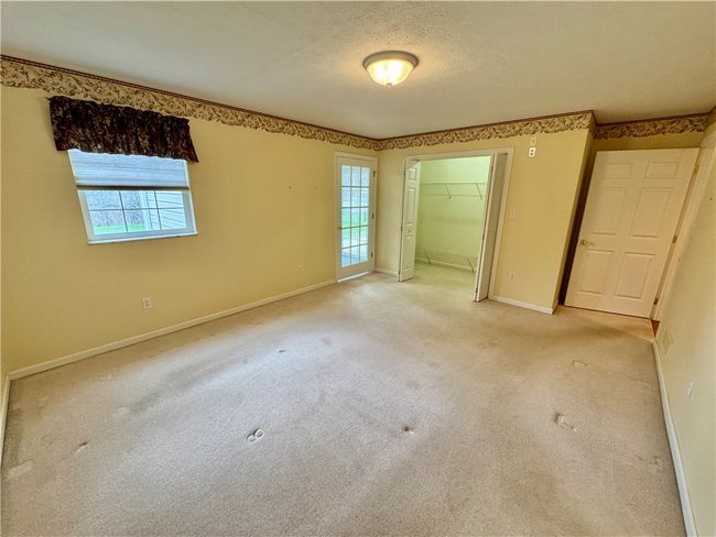 The master bedroom has a 9x4 walk-in closet and access to the den. | Image 11