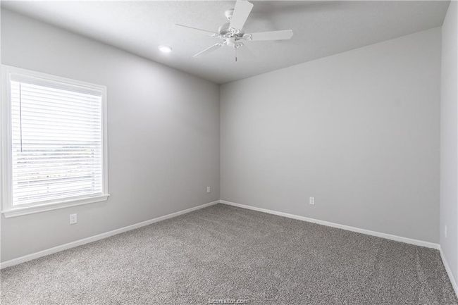 Carpeted empty room featuring ceiling fan | Image 14