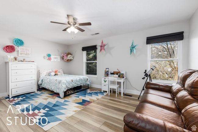 Bedroom featuring light wood-type flooring, visible vents, a ceiling fan, and baseboards | Image 20