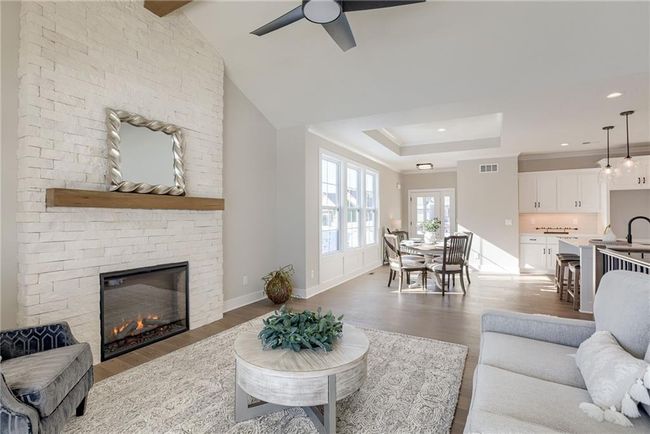 Living area featuring visible vents, baseboards, a ceiling fan, and wood finished floors | Image 8