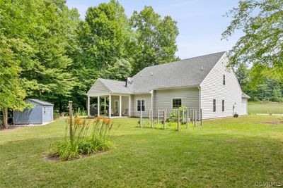 Craftsman-style home featuring a porch, a garage, and a front yard | Image 2