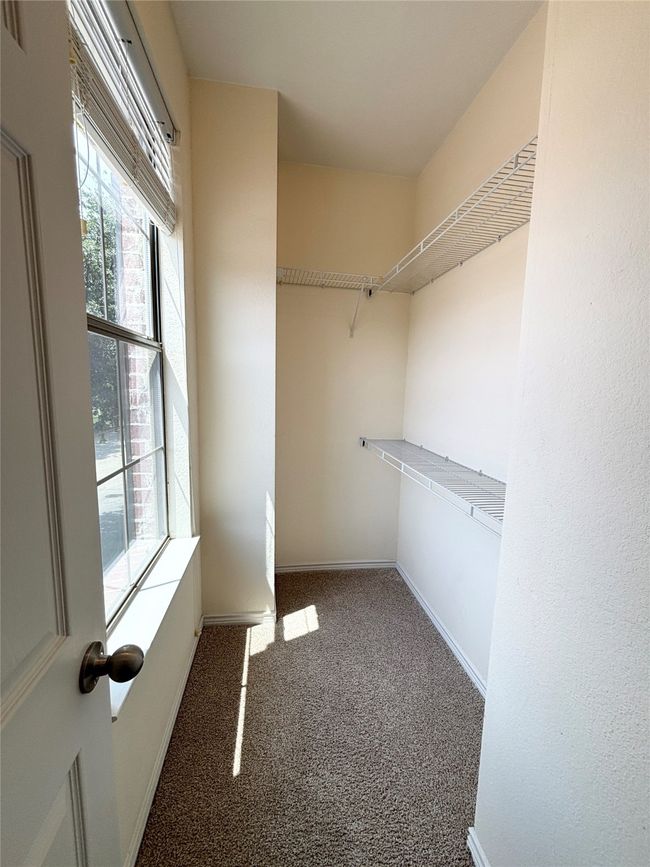 Spacious closet with carpet floors | Image 12