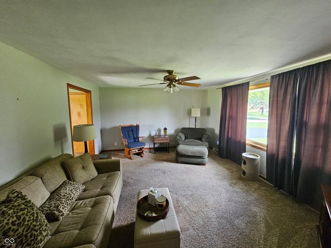 carpeted living room featuring ceiling fan | Image 10