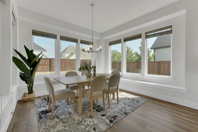 Dining room featuring wood finished floors, a chandelier, and plenty of natural light | Image 15