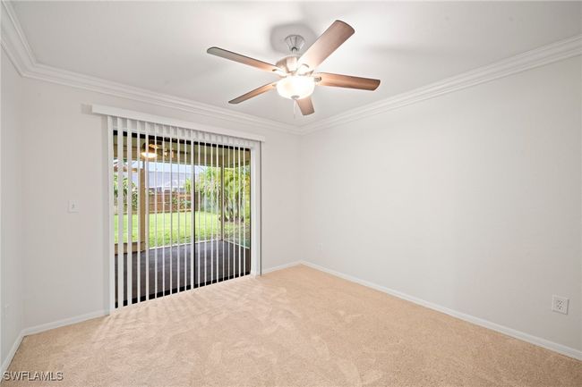 Carpeted empty room with ornamental molding and a ceiling fan | Image 21