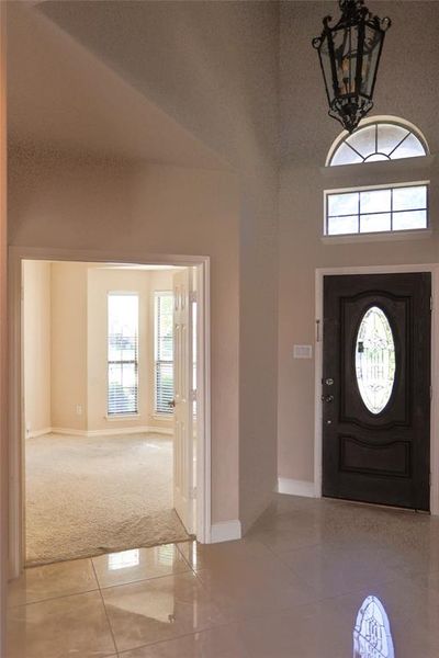 Tiled entryway featuring high vaulted ceiling and a notable chandelier | Image 3