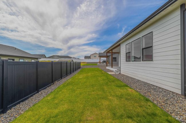 View of fenced backyard | Image 35
