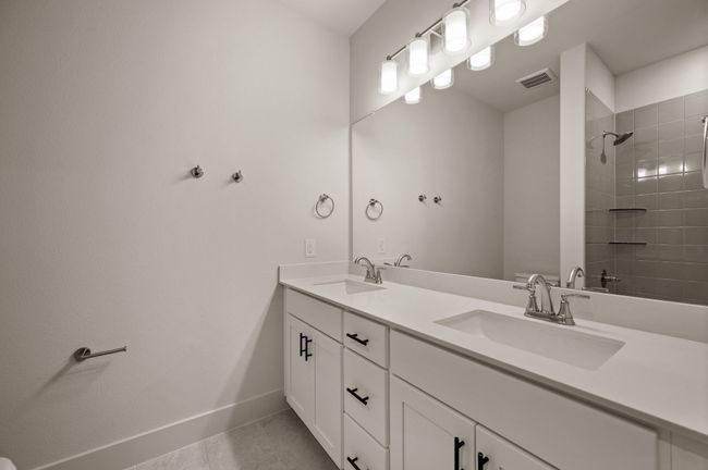 Guests will enjoy their own vanity space in this thoughtfully designed guest bath. | Image 16