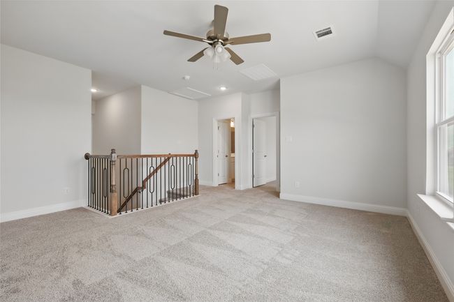 Unfurnished room featuring light colored carpet, visible vents, ceiling fan, and baseboards | Image 23
