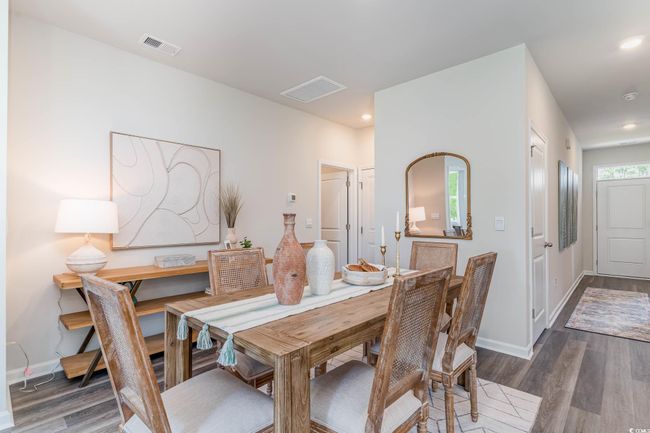 Dining room with dark wood-style flooring and recessed lighting | Image 7