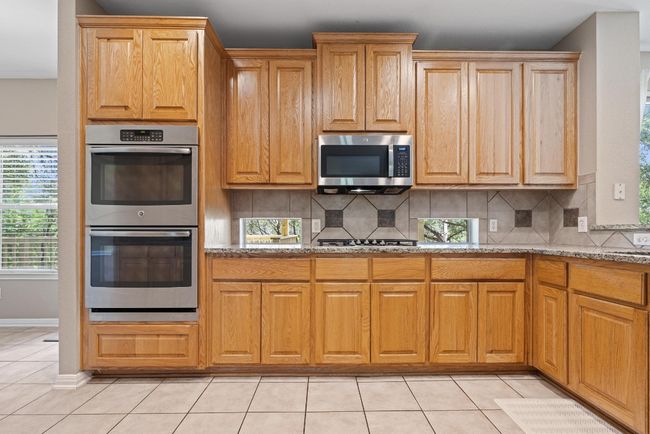 With granite countertops, stainless appliances, and rich cabinetry, the kitchen balances warmth and practicality in a space that’s made to be used | Image 13