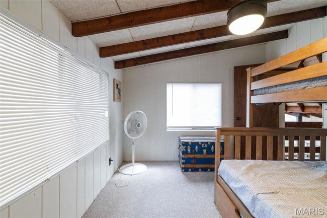 Bedroom with beam ceiling and carpet floors | Image 37