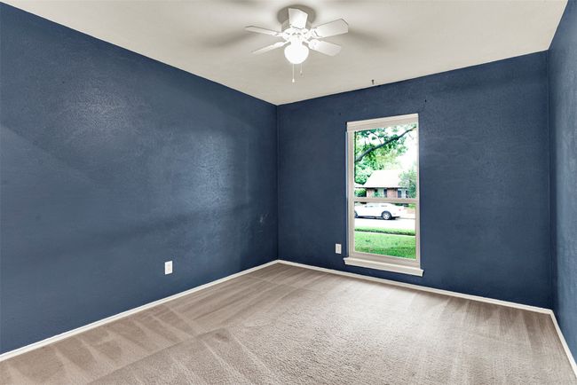 Spare room with a ceiling fan and carpet | Image 15