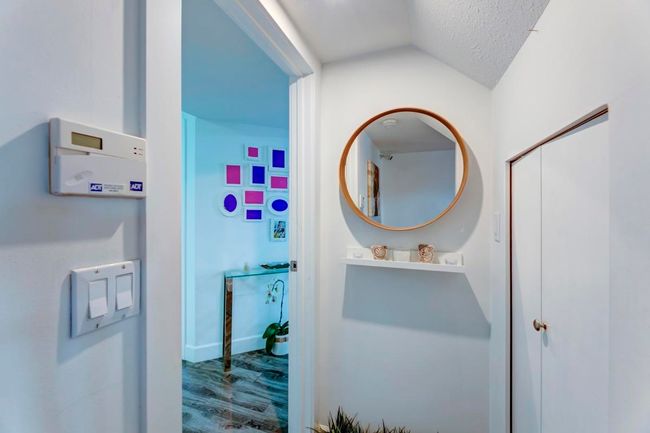 Bathroom featuring vaulted ceiling, a textured ceiling, and wood finished floors | Image 23