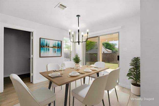 Dining room featuring a chandelier & LVP flooring | Image 6