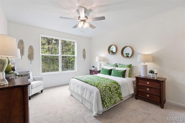 Bedroom with light colored carpet, baseboards, and ceiling fan | Image 21