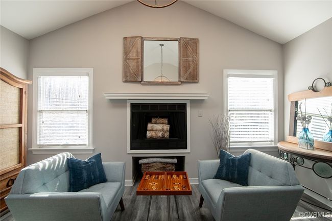 Living room featuring vaulted ceiling, wood finished floors, and baseboards | Image 9