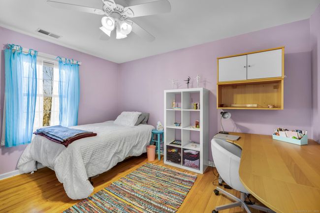 Bedroom #2 with hardwood floor and ceiling fan. | Image 21