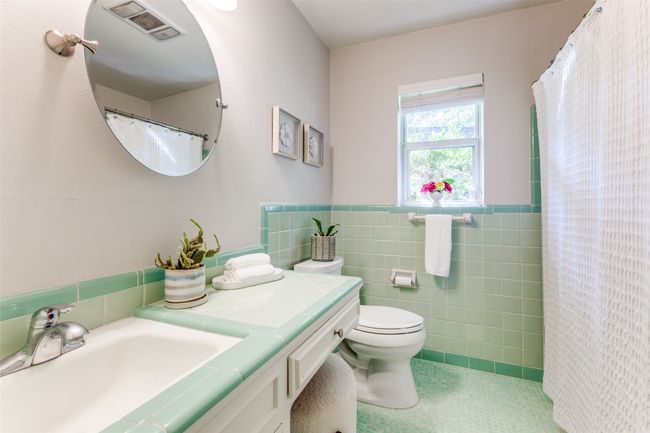 Bathroom with vanity, tile walls, a wainscoted wall, tile patterned flooring, and curtained shower | Image 15