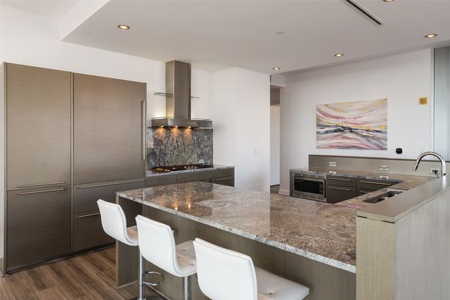 Kitchen has built in Subzero refrigerator and Miele gas cooktop. | Image 15
