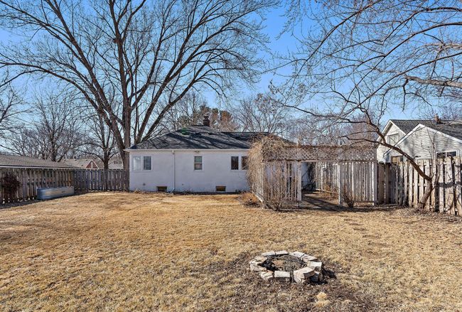 The backyard has a fire pit, perfect for hosting outdoor gatherings. | Image 28