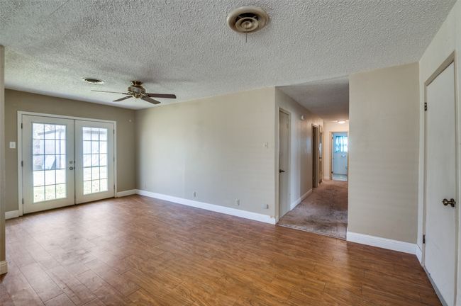 Unfurnished room featuring french doors, ceiling fan, a textured ceiling, and hardwood / wood-style flooring | Image 8