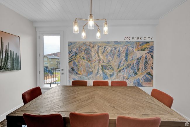 Dining room with plenty of natural light, a chandelier, and wood ceiling | Image 17