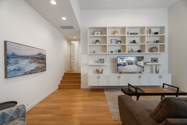 Living area featuring light wood-style flooring, baseboards, recessed lighting, and stairway | Image 22
