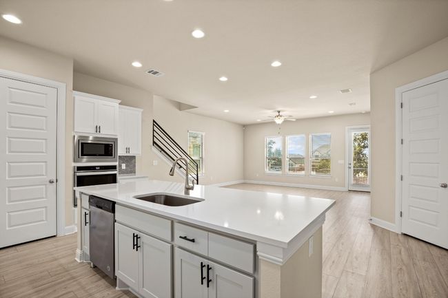 Kitchen with a ceiling fan, a sink, a wealth of natural light, visible vents, and appliances with stainless steel finishes | Image 9