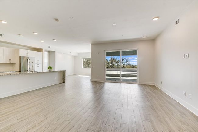 Unfurnished living room with visible vents, recessed lighting, baseboards, and light wood-style floors | Image 5