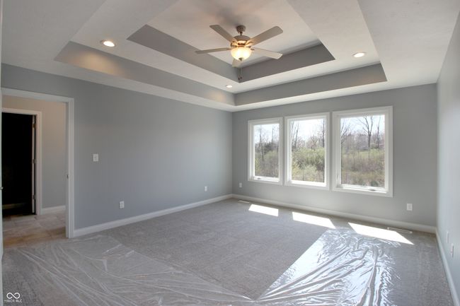 empty room featuring recessed lighting, a raised ceiling, and light carpet | Image 10