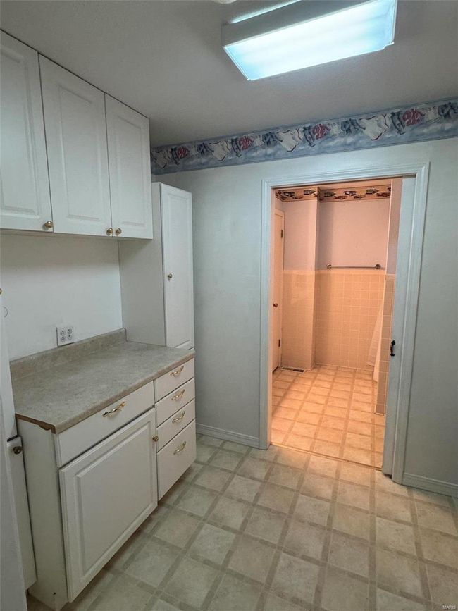 Kitchen featuring white cabinets | Image 7