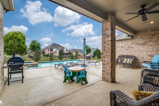 Fenced backyard with ceiling fan, a patio, a grill, and an outdoor living space | Image 26