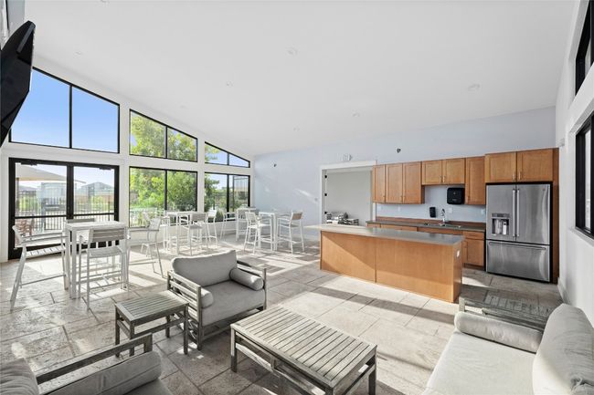 Living area with high vaulted ceiling and stone tile floors | Image 23