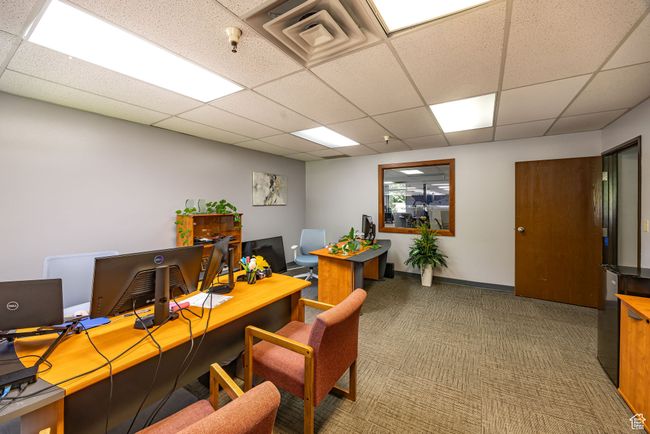 Carpeted office featuring a drop ceiling and baseboards | Image 15