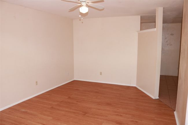 Empty room featuring a ceiling fan, light wood-type flooring, and baseboards | Image 5