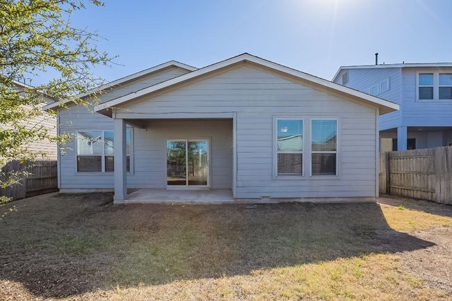 Back of house with a fenced backyard, a yard, and a patio area | Image 33