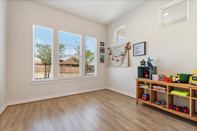 Rec room with baseboards, wood finished floors, and a healthy amount of sunlight | Image 24