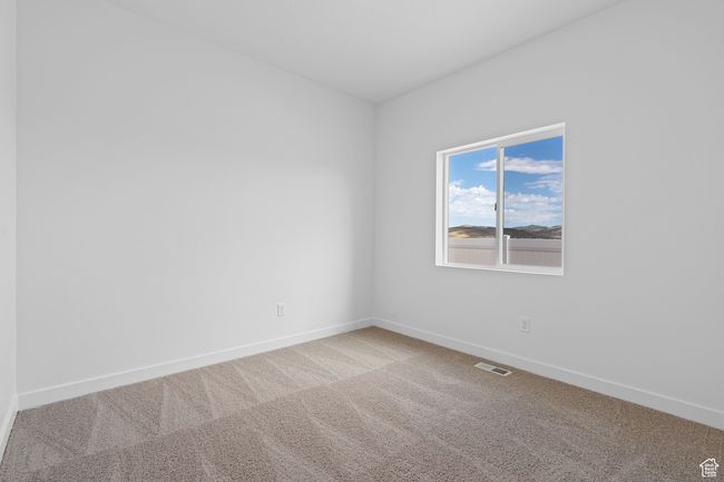 Carpeted spare room featuring visible vents and baseboards | Image 10