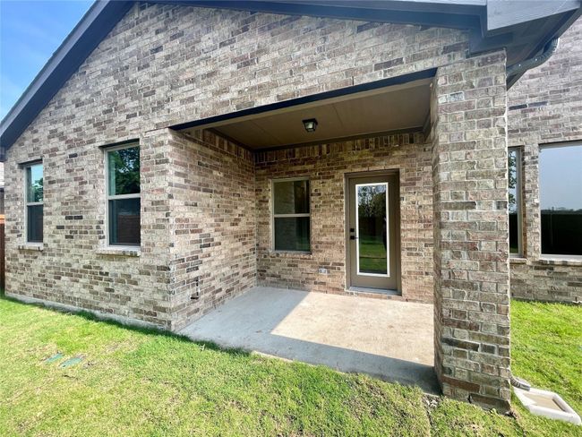 Property entrance featuring a patio, brick siding, and a yard | Image 39